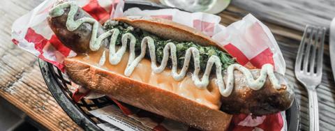 A hot dog with toppings.