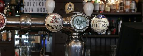 View of several beers taps at a bar.